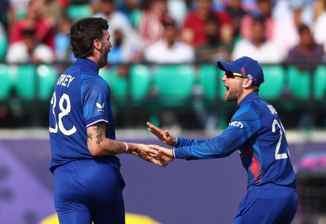 England's Reece Topley celebrates after taking the wicket of Bangladesh's Najmul Hossain Shanto, caught by Liam Livingstone