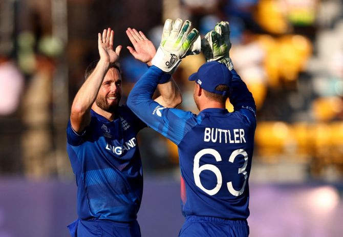 England's Chris Woakes celebrates after taking the wicket of Bangladesh's Liton Das, caught by Jos Buttler