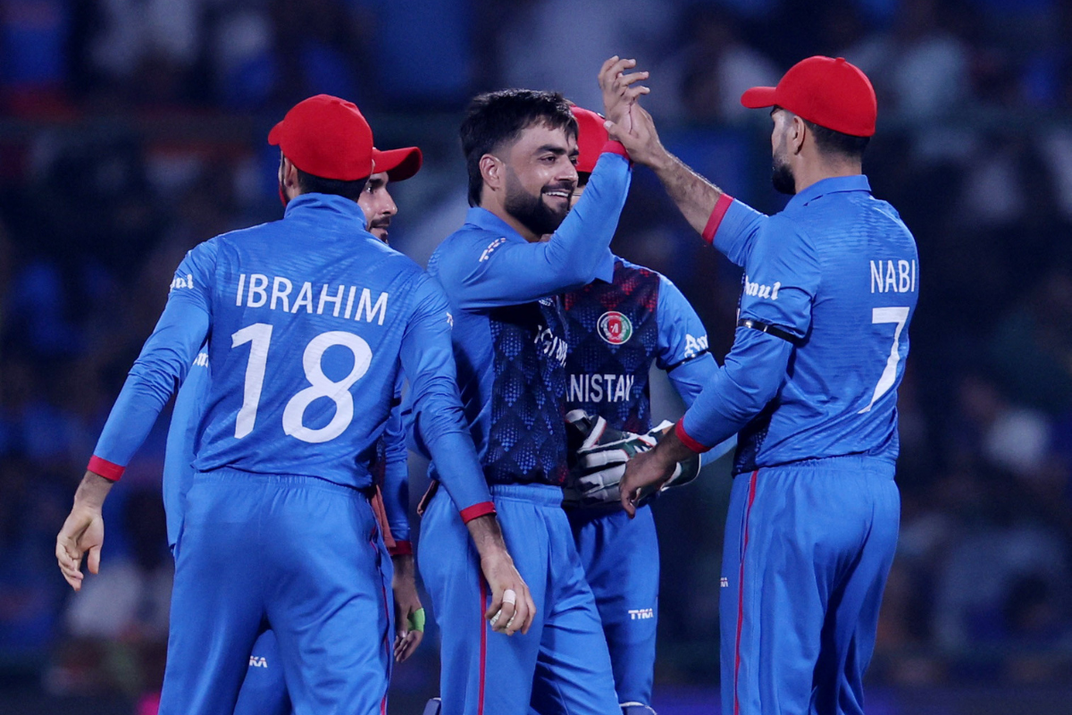 Afghanistan's Rashid Khan celebrates after taking the wicket of India's Ishan Kishan, caught by Ibrahim Zadran