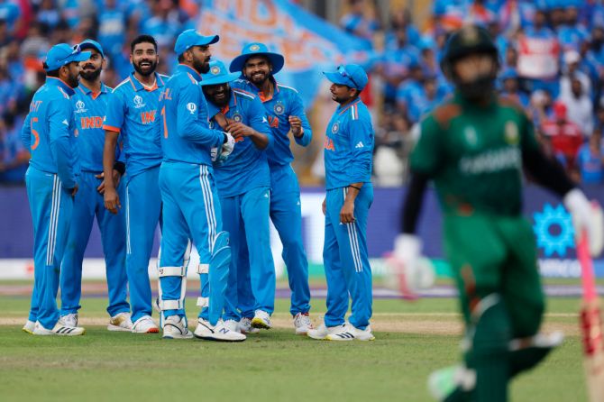 India's Ravindra Jadeja celebrates with teammates after taking a catch to dismiss Bangladesh's Mushfiqur Rahim off the bowling of Jasprit Bumrah