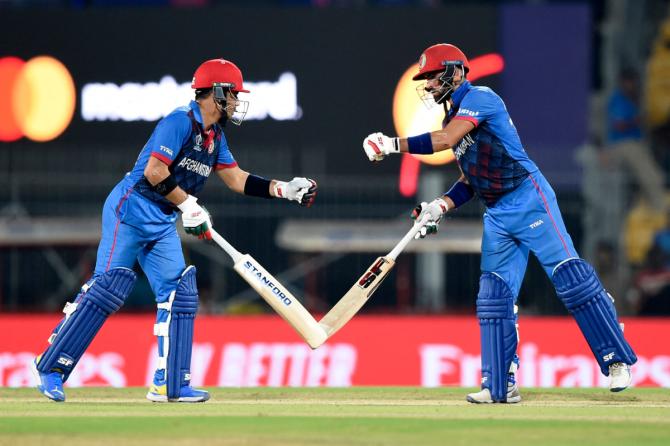 Afghanistan's Ibrahim Zadran and Rahmanullah Gurbaz bump fists during their innings