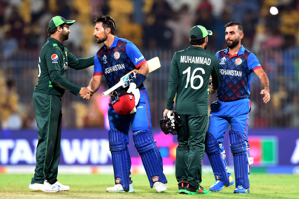 Afghanistan's Rahmat Shah and Hashmatullah Shahidi are congratulated by Pakistan's Mohammad Rizwan and Imam-ul-Haq after winning the match by 8 wickets