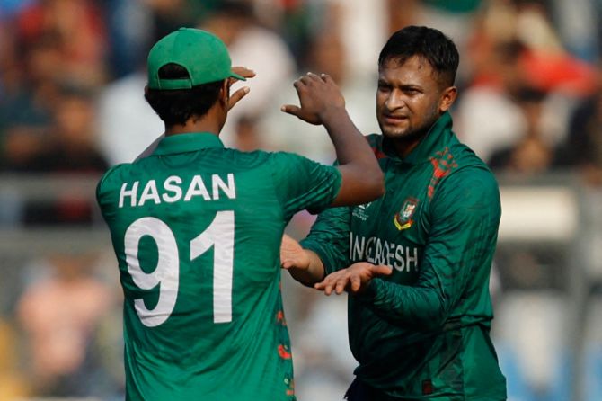 Shakib Al Hasan celebrates with Hasan Mahmud after taking the wicket of Aiden Markram.