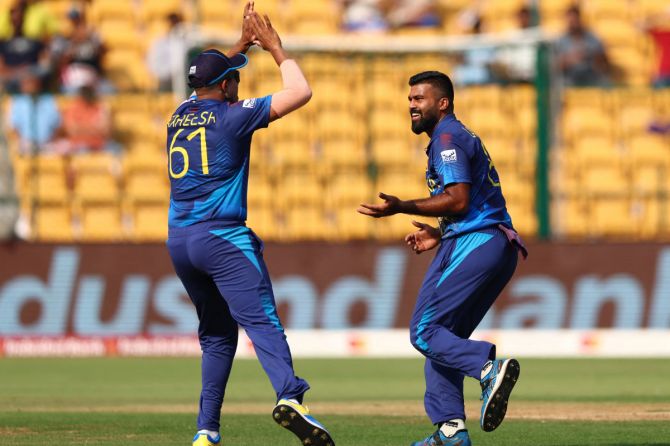 Sri Lanka's Lahiru Kumara celebrates with Maheesh Theekshana after taking the wicket of England's Jos Buttler