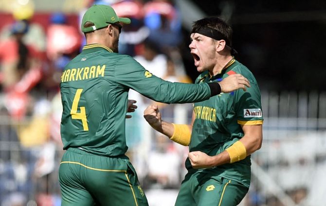 Gerald Coetzee celebrates with Aiden Markram after taking the wicket of Mohammad Rizwan