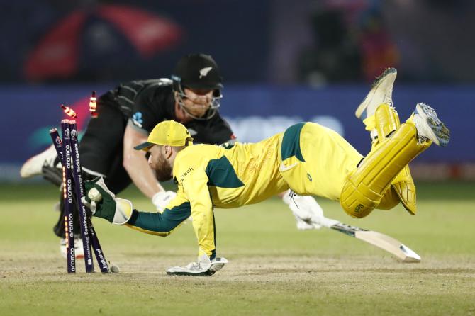 Josh Inglis breaks the stumps to run out Jimmy Neesham 