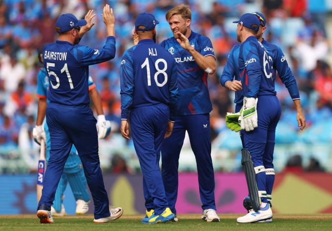 David Willey celebrates with teammates after taking the wicket of Virat Kohli