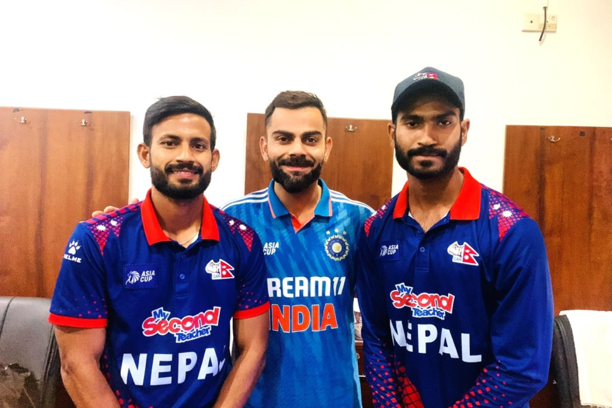 Nepal's Asif Shaikh (left) and a teammate with Virat Kohli