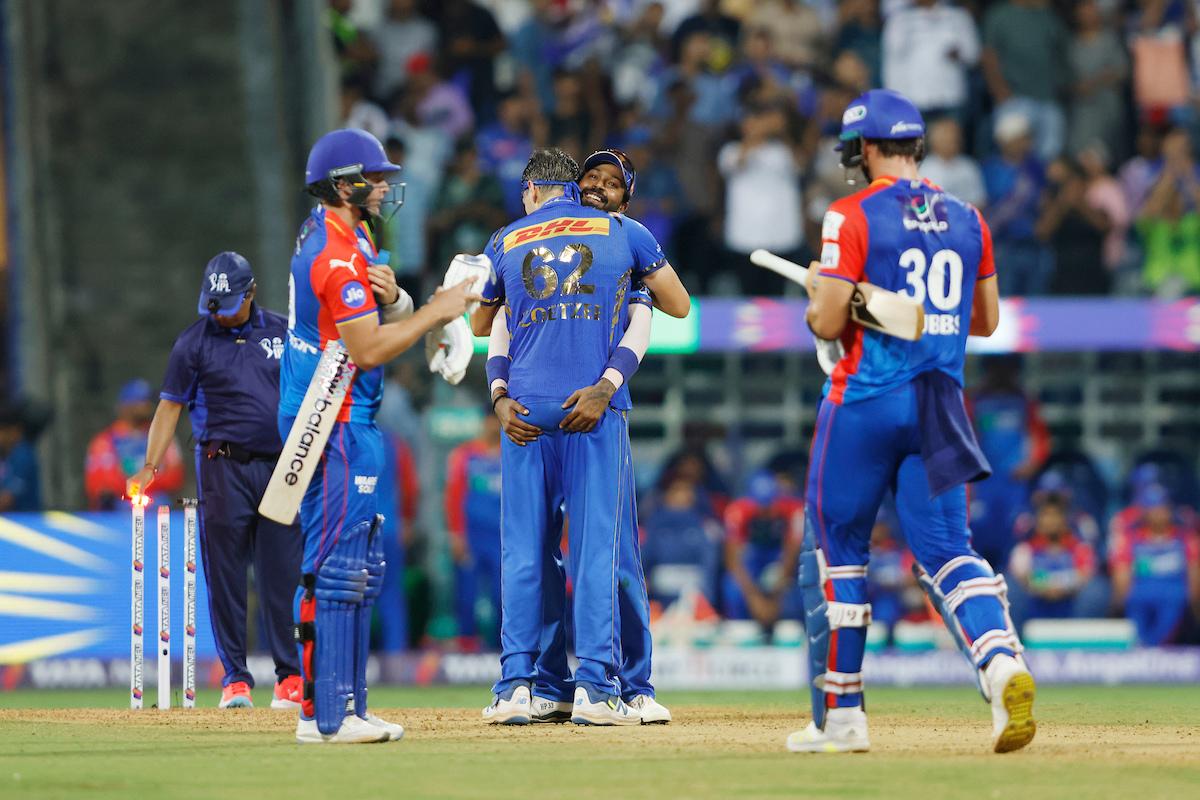 Gerald Coetzee of Mumbai Indians and Hardik Pandya (c) of Mumbai Indians celebrate the wicket of Delhi Capitals' Jhye Richardson 