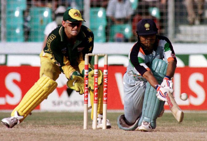 Sachin Tendulkar plays the paddle sweep past wicketkeeper Adam Gilchrist during an One-Day International against Australia in Dhaka, on October 28, 1998.