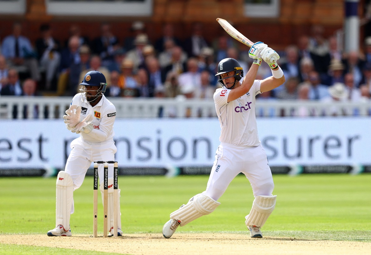 Jamie Smith sends the ball to the boundary.