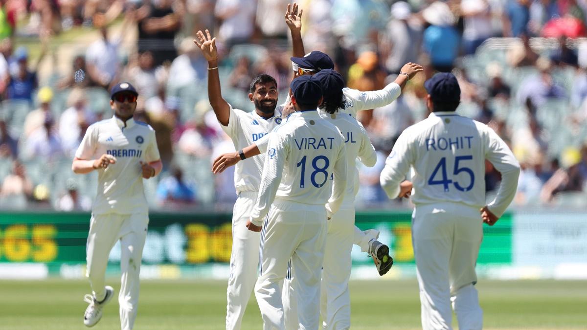 Jasprit Bumrah celebrates with his India teammates after dismissing Australia's overnight batter Nathan McSweeney