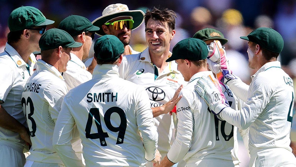 Pat Cummins celebrates a wicket with team-mates