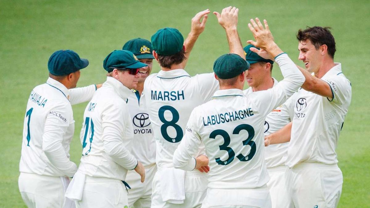 Pat Cummins celebrates with his Australia teammates after dismissing Rohit Sharma