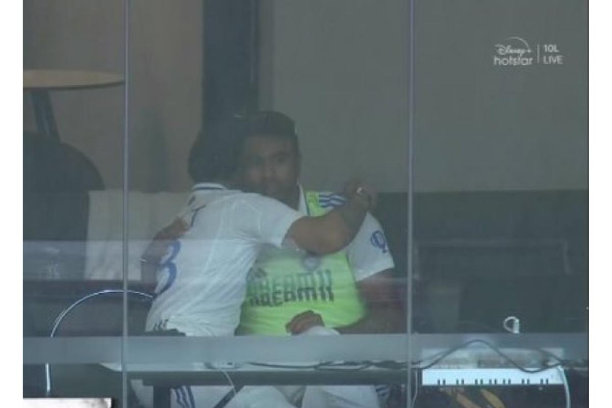 Virat Kohli hugs Ravichandran Ashwin in the dressing room at The Gabba in Brisbane during the tea break on Day 5 of the 3rd Test