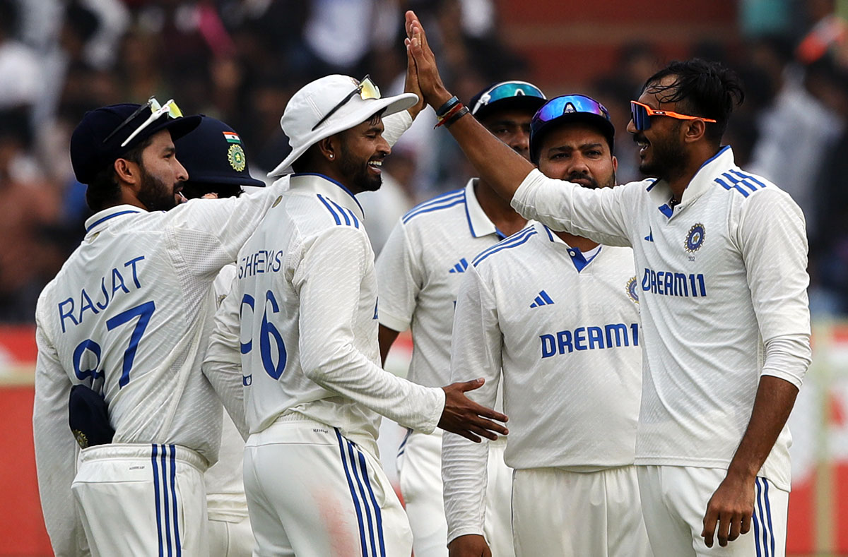 Axar Patel celebrates with team-mates after taking the wicket of Rehan Ahmed