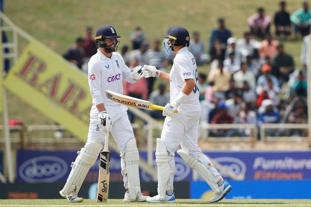 England's Ben Foakes congratulates Joe Root on completing his half century