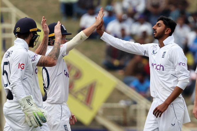England's Shoaib Bashir celebrates with Ollie Pope and Ben Foakes after taking out India's Akash Deep LBW