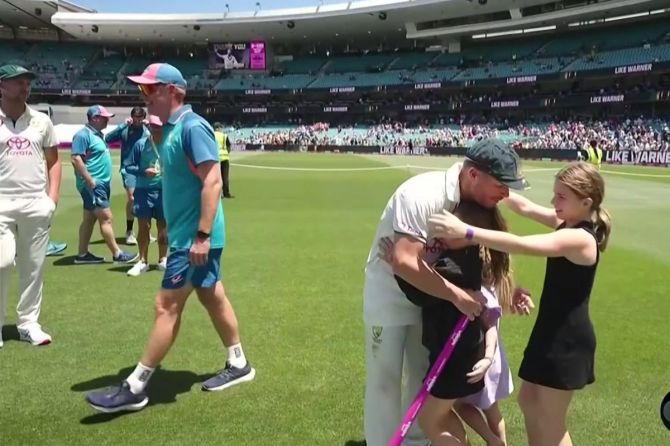 David Warner hugs his daughter's after the match on Saturday