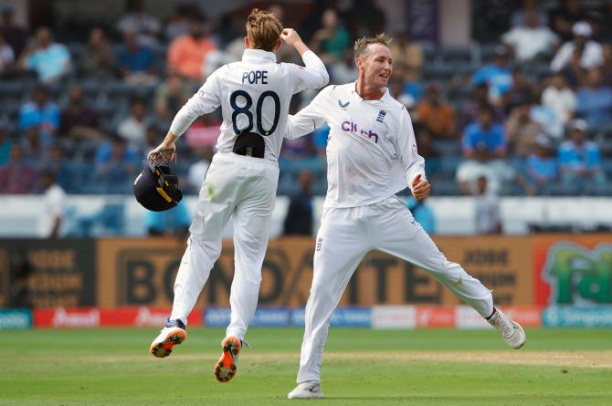 Tom Hartley celebrates with team-mate Ollie Pope after taking the wicket of Shubman Gill