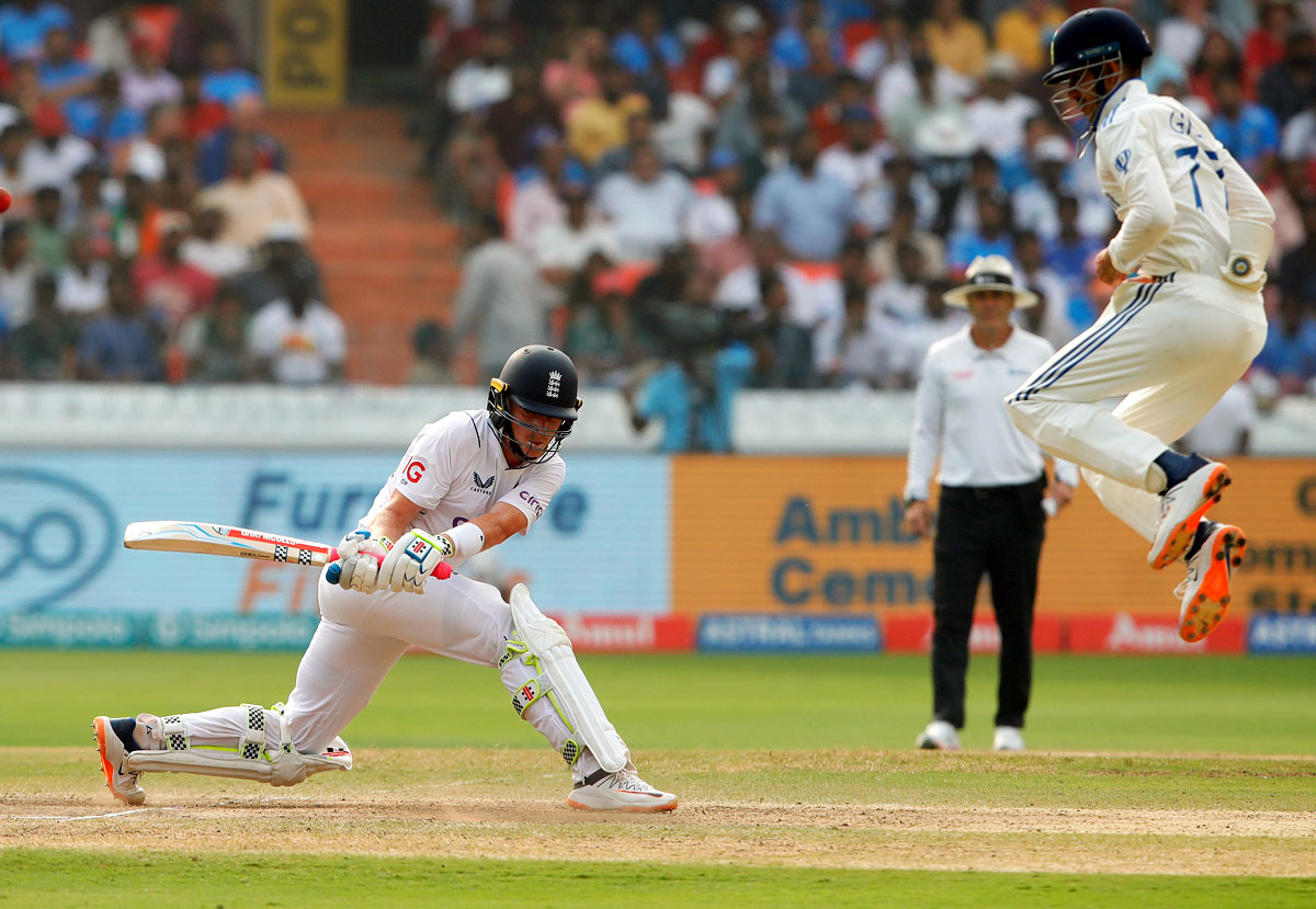 Ollie Pope plays the reverse sweep for a boundary as Shubman Gill at silly point takes evasive action