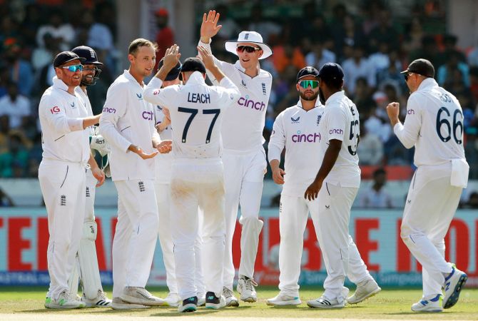 Tom Hartley celebrates with team-mates after taking the wicket of Axar Patel.