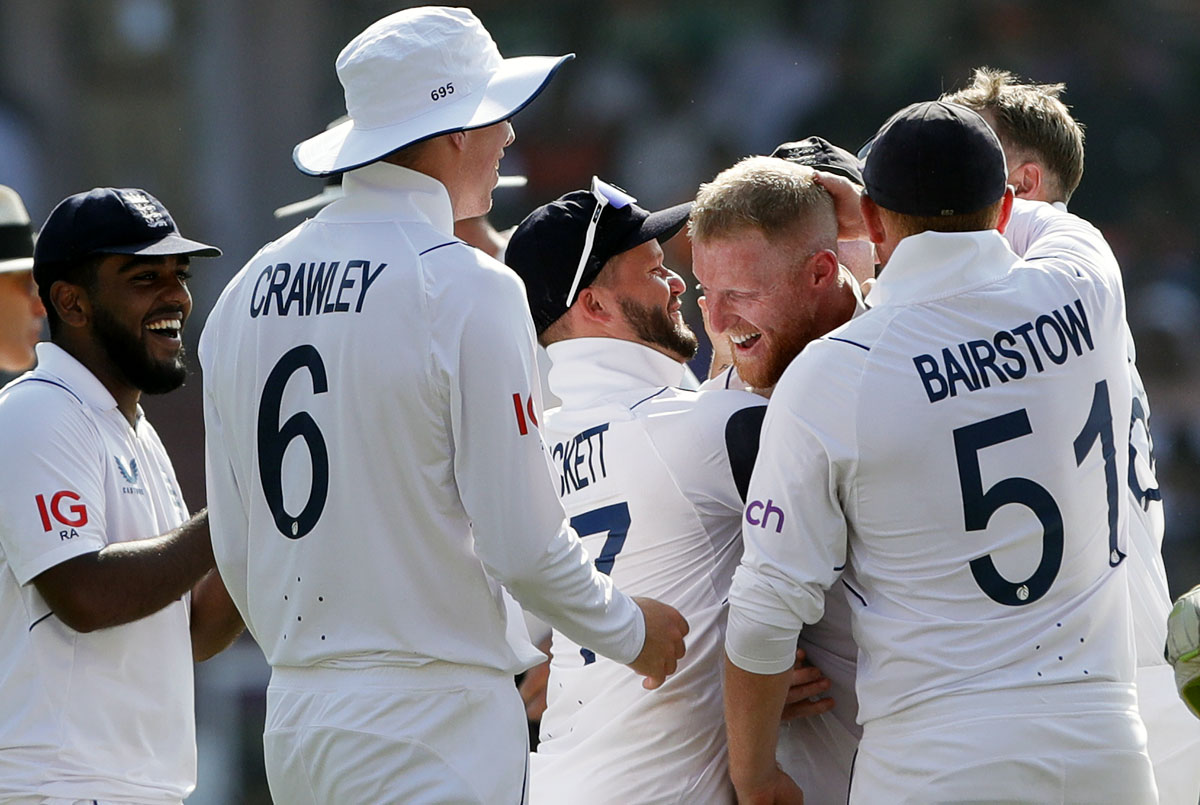 England's players celebrate after Ben Stokes ran out Ravindra Jadeja with a direct hit.