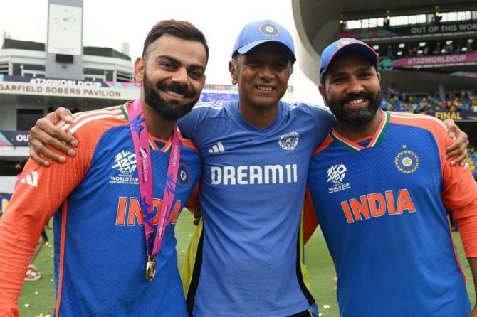 Three stalwarts of Indian cricket, Virat Kohli, Head Coach Rahul Dravid and captain Rohit Sharma celebrate after winning the T20 World Cup, on Saturday, July 29