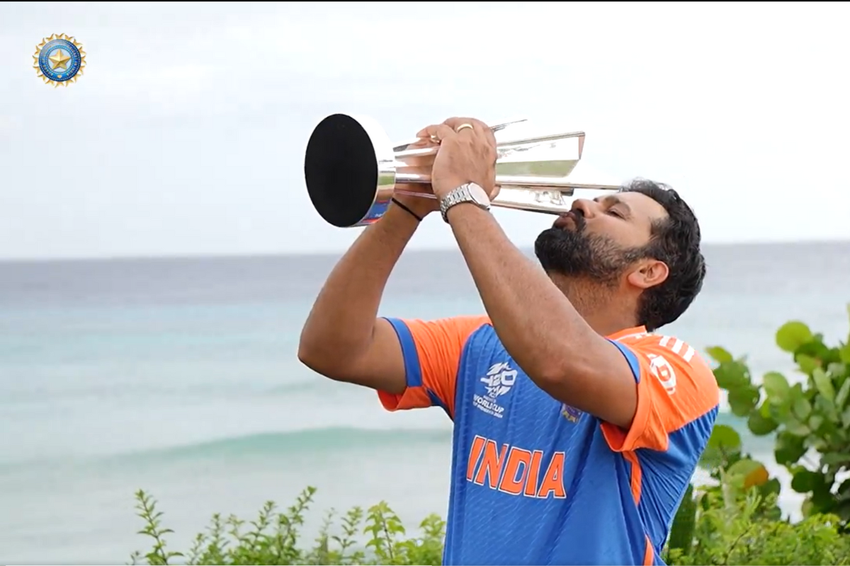 Rohit Sharma kisses the trophy at the post-match photo shoot at a beach in Bridgetown, Barbados, on Sunday