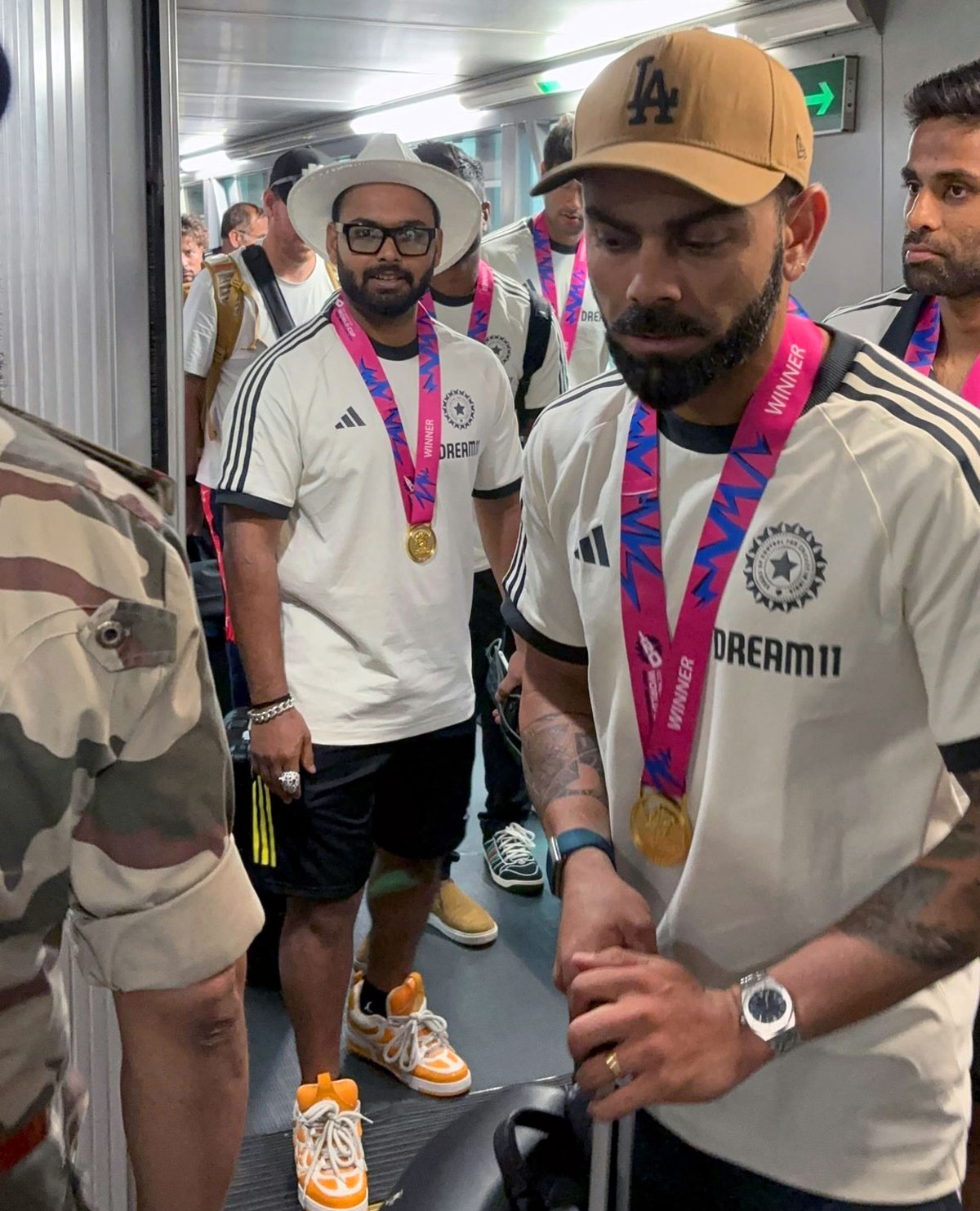 Virat Kohli leads the players out of the airport