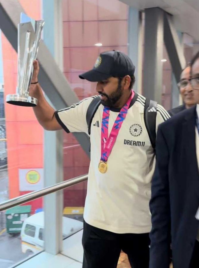 India skipper Rohit Sharma holds aloft the T20 World Cup trophy as he walks down the Indira Gandhi International Airport in Delhi on Thursday morning.