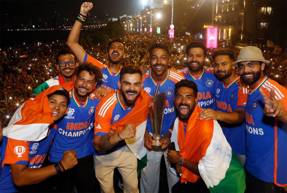  The jubilant Indian players celebrate with the T20 World Cup trophy atop an open top bus during the victory parade in Mumbai on July 5, 2024