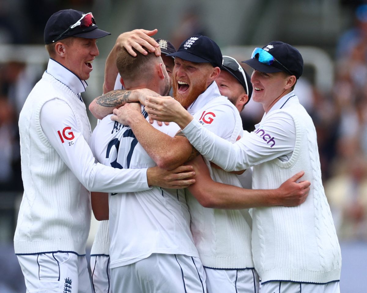 Gus Atkinson celebrates his five-wicket-haul with teammates.