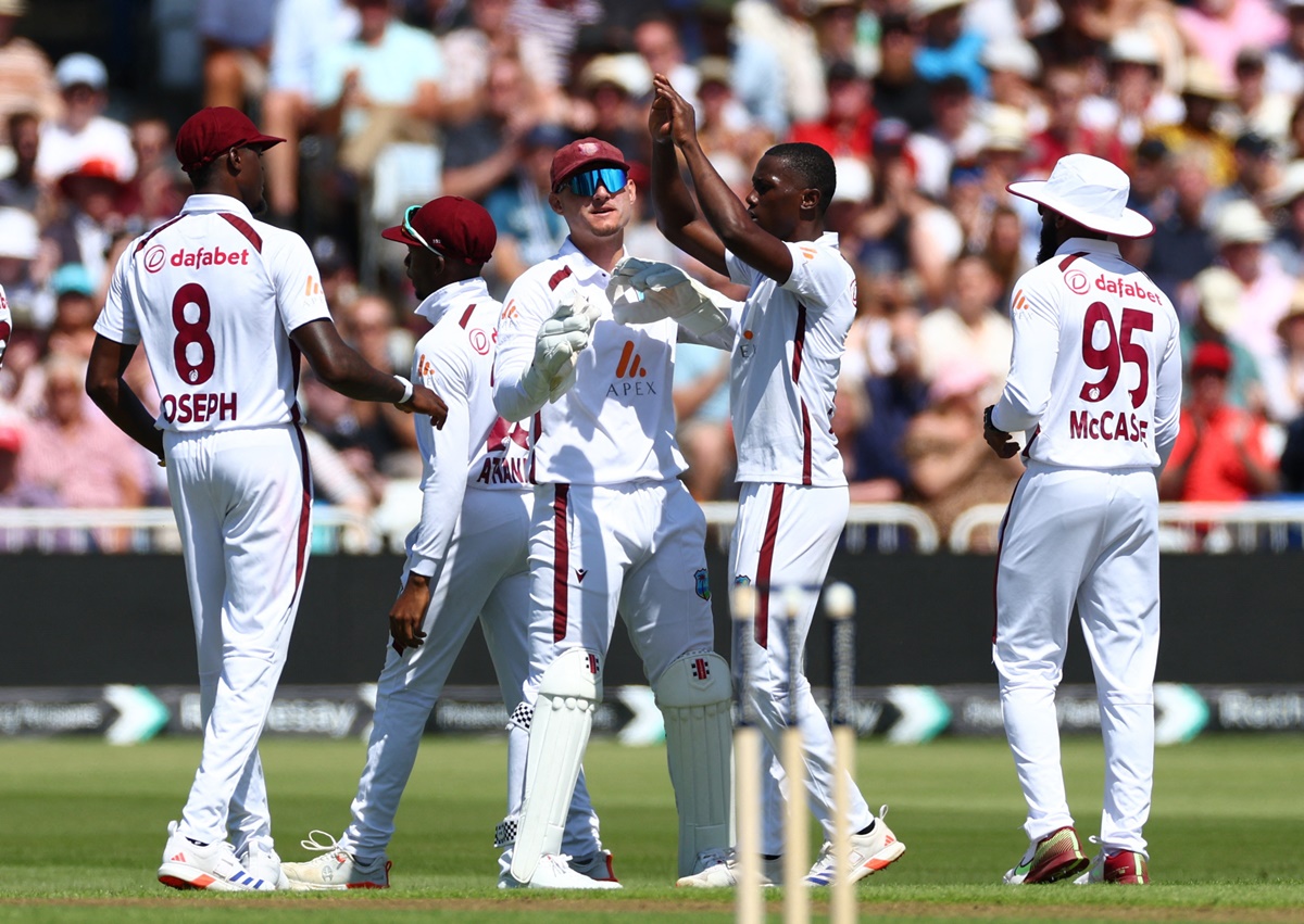 West Indies pacer Shamar Joseph celebrates with teammates after taking the wicket of Ben Duckett, caught by Jason Holder. 