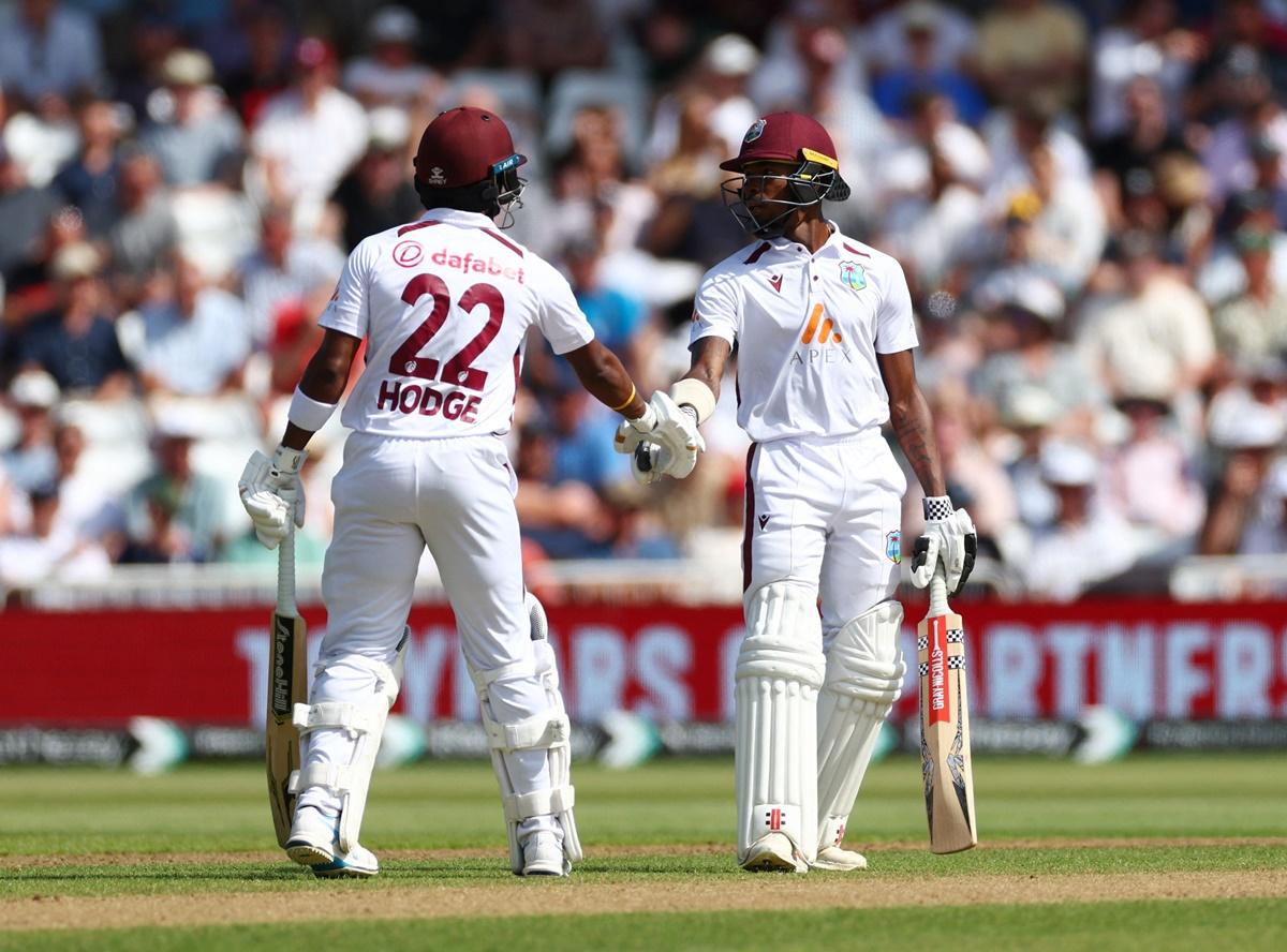 Kavem Hodge and Alick Athanaze celebrate taking the West Indies past the 200-run mark.