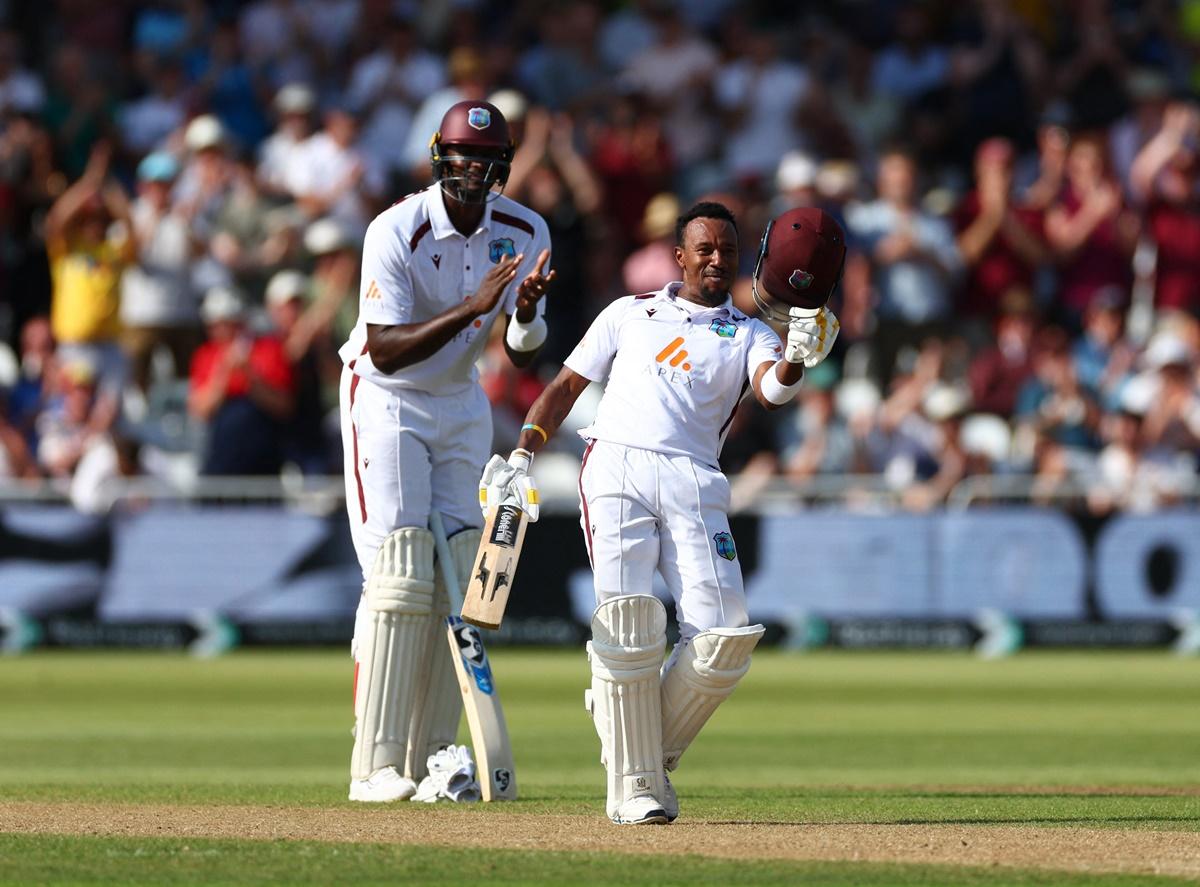 Jason Holder applauds as his West Indies teammate Kavem Hodge celebrates scoring his first Test century on Day 2 of the second Test against England at Trent Bridge, Nottingham, on Friday.