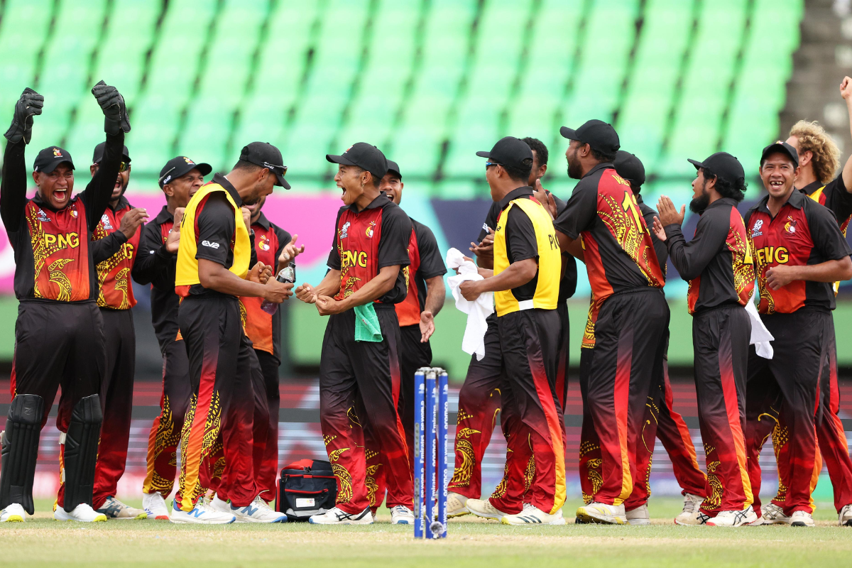 Papua New Guinea players celebrate the fall of a West Indies wicket