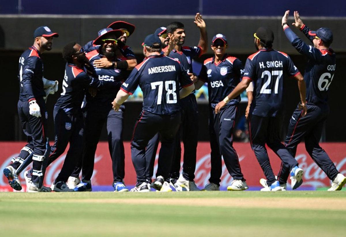 The USA players celebrate the fall of a Pakistan wicket