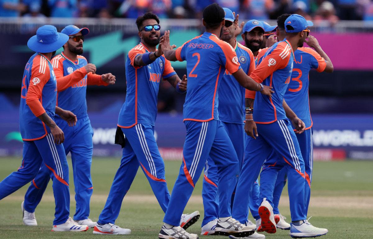 India pacer Arshdeep Singh celebrates the wicket of Pakistan's Imad Wasim with teammates during the 20 World Cup Group A match between India and Pakistan in New York on Sunday