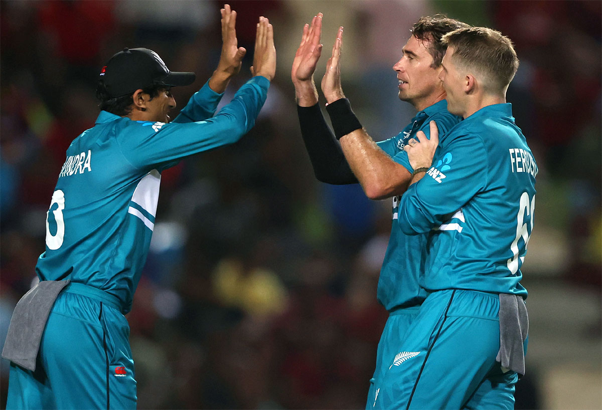 Tim Southee celebrates one of his two wickets with teammates.