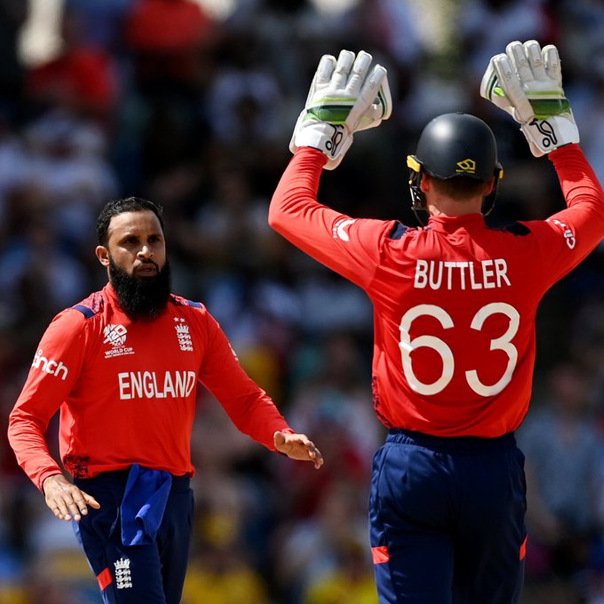 England spinner Rashid was celebrates with Jos Buttler after dismissing Oman's Kaleemullah during the T20 World Cup Group C match in Antigua on Friday.