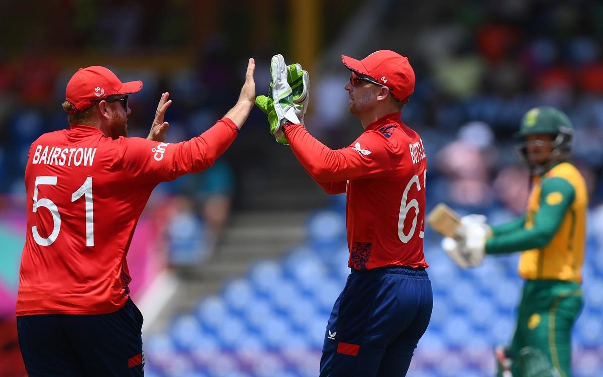 Jos Buttler celebrates withJonny Bairstow after taking a brilliant catch to dismiss Quinton de Kock 