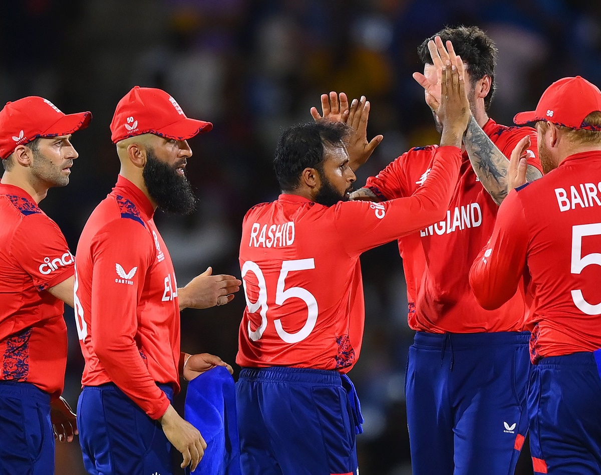 Adil Rashid gets a round of high-five from his England teammates after dismissing Aiden Markram.