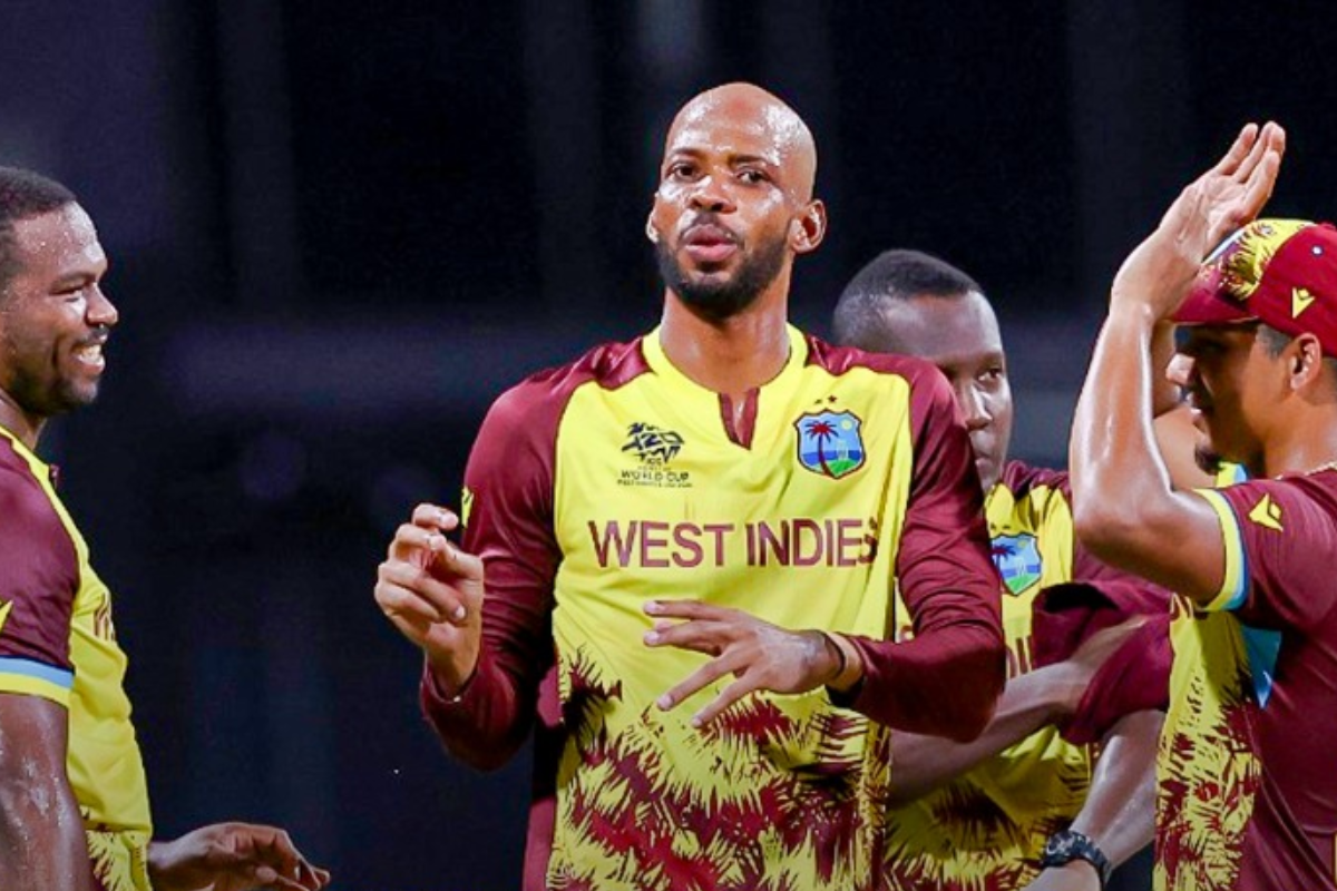Roston Chase celebrates withhis West Indies teammates after picking a wicket