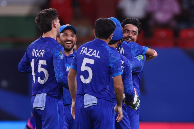 Afghan captain Rashid Khan celebrates with teammates after stunning Australia in Kingstown, St Vincent, on Sunday