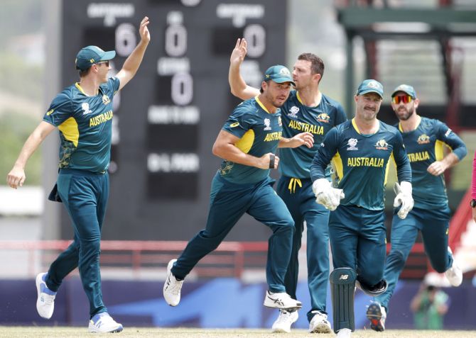 Josh Hazlewood and his Australia teammates celebrate the wicket of Virat Kohli.