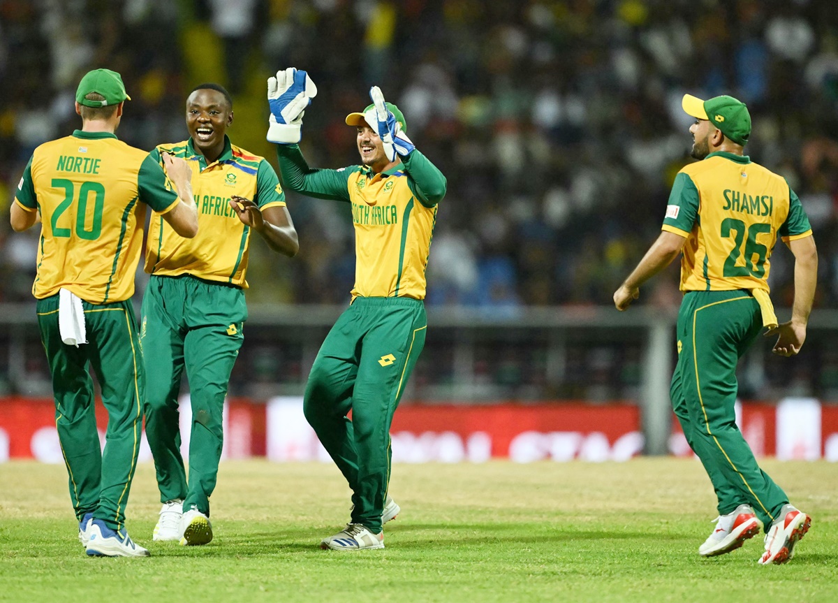 Kagiso Rabada celebrates with his South Africa teammates after dismissing Akeal Hosein