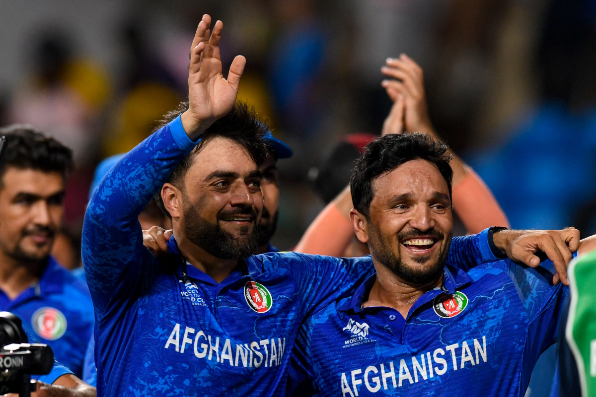 Rashid Khan and Gulbadin Naib celebrate after booking a place in the T20 WC emis