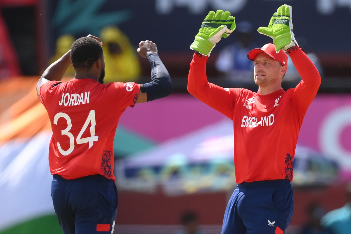 England's Chris Jordan celebrates a wicket with captain Jos Buttler