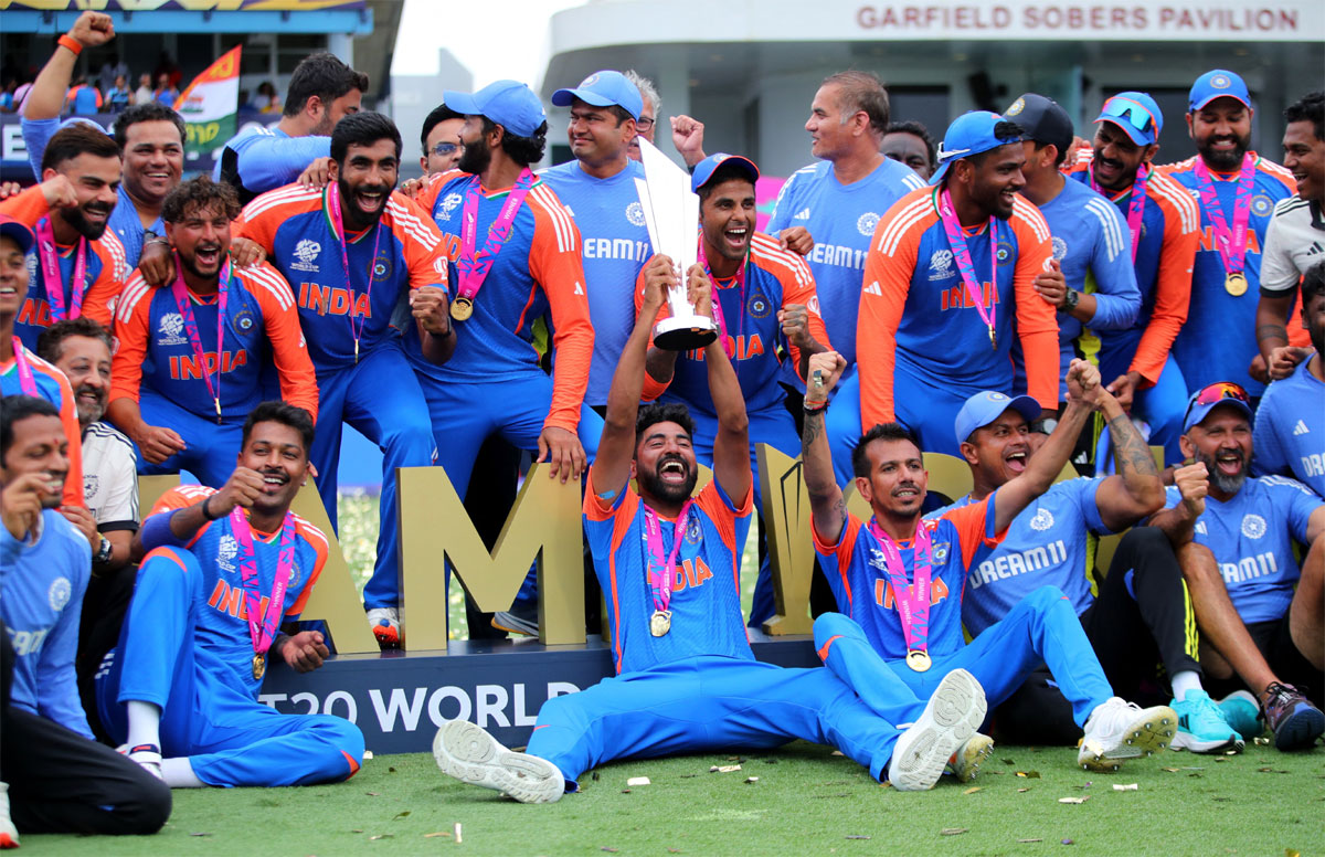 India pacer Mohammed Siraj hoists the T20 World Cup trophy as the team celebrates 